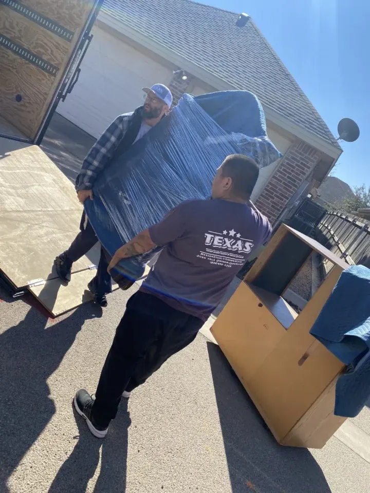 West Texas Master Movers carrying boxes two members of West Texas Master Movers carrying boxes